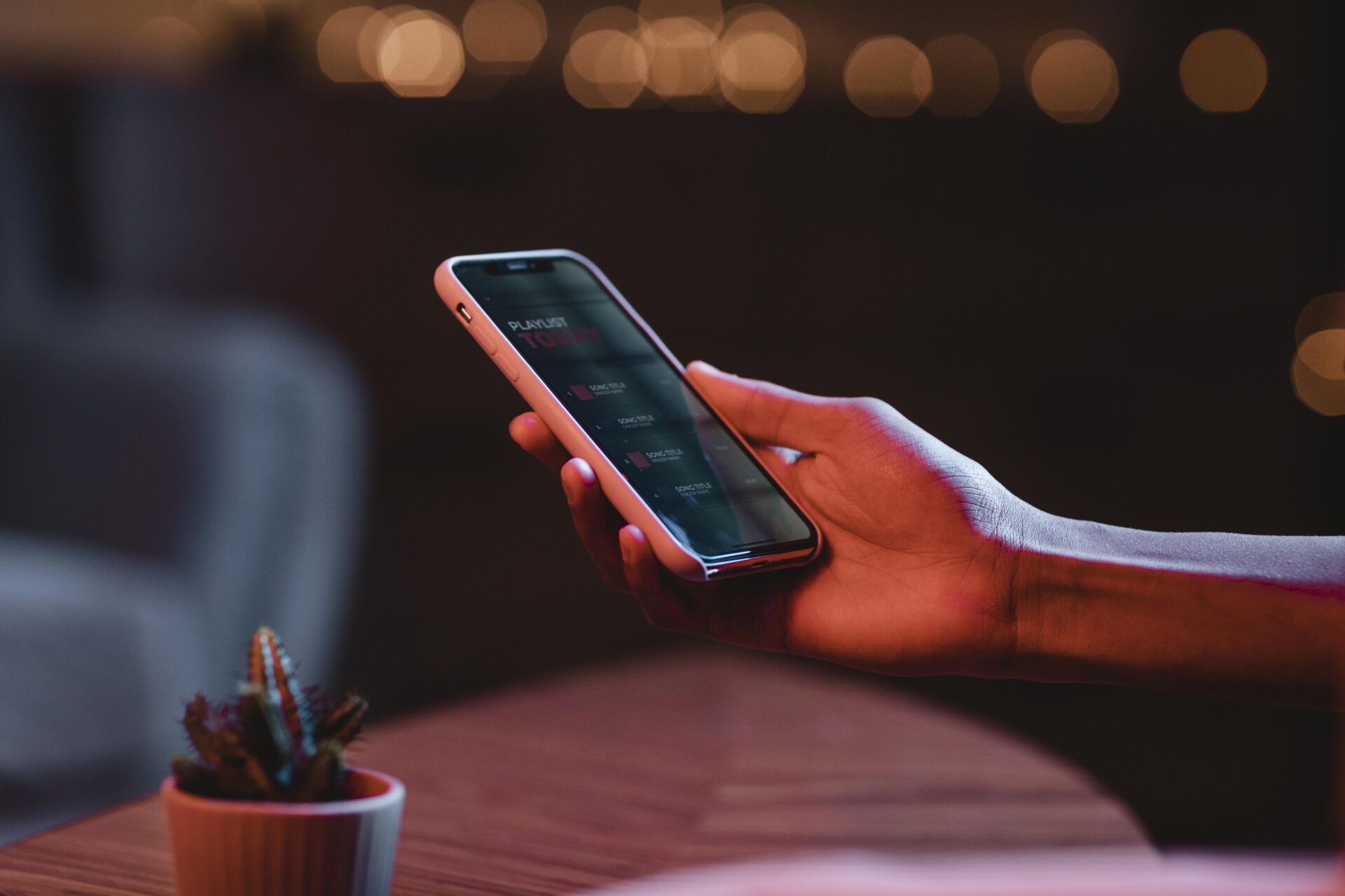 (Image by freepik ) side-view-man-holding-smartphone-hand